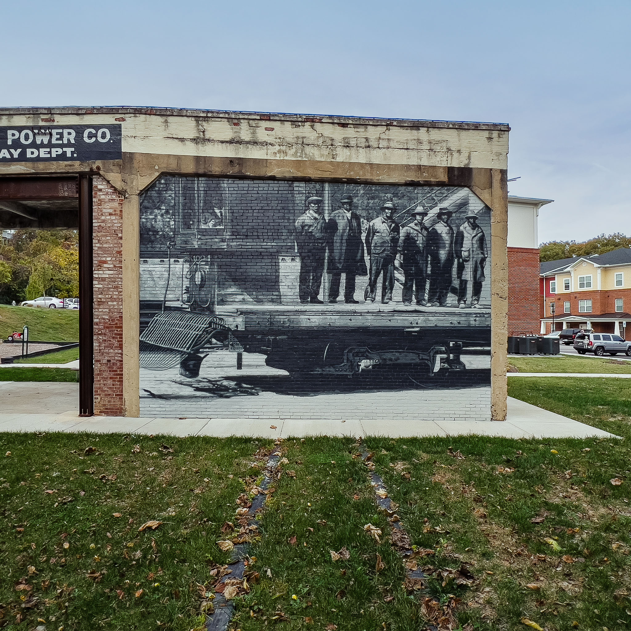 The murals wrap both sides of each freestanding wall. Walking around reveals additional content and maintains the narrative beyond the primary viewing angle.